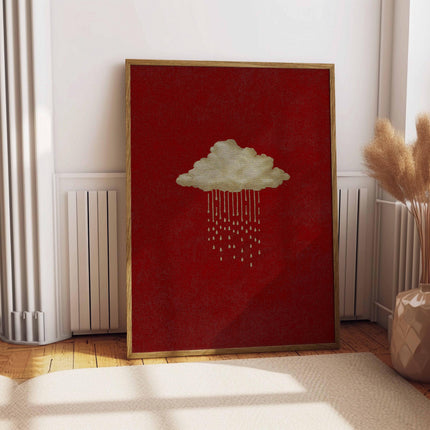 May include: A framed art print depicting a cloud with rain droplets against a red backdrop. The cloud and rain are gold, and the frame is light brown. The artwork is displayed on a white wall and a beige rug.
